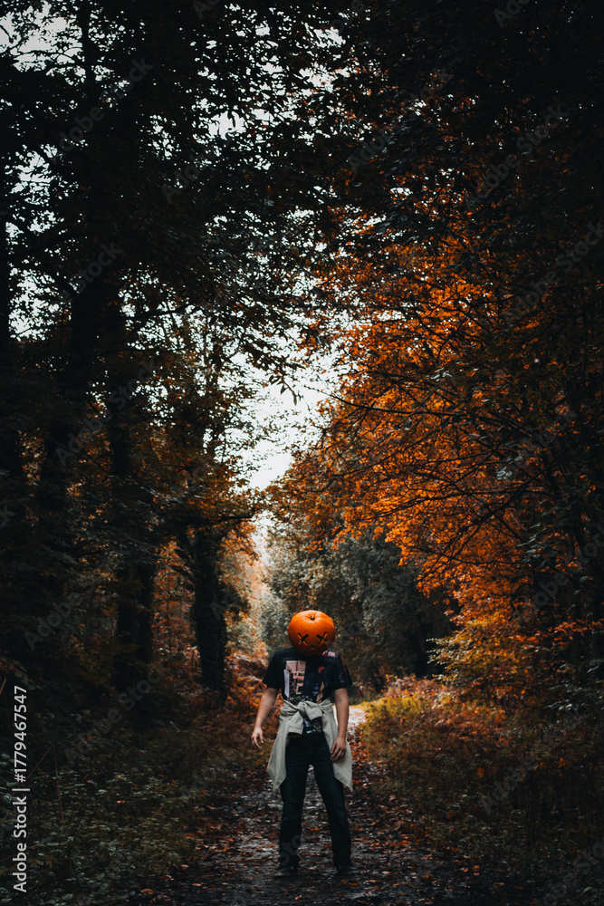 Fototapeta premium Man dressed in carved pumpkin for Halloween