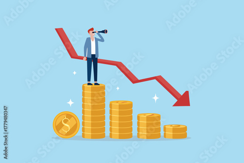 Man with spyglass standing on stacked coins looking at a downward trending red arrow