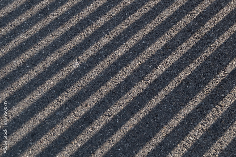 Fototapeta premium A black and white photo of a road with a lot of shadows