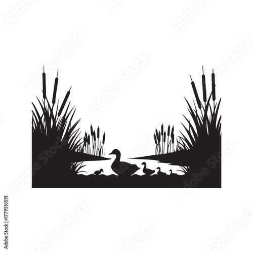 Black duck and cattail reeds in silhouette against a colorful sky