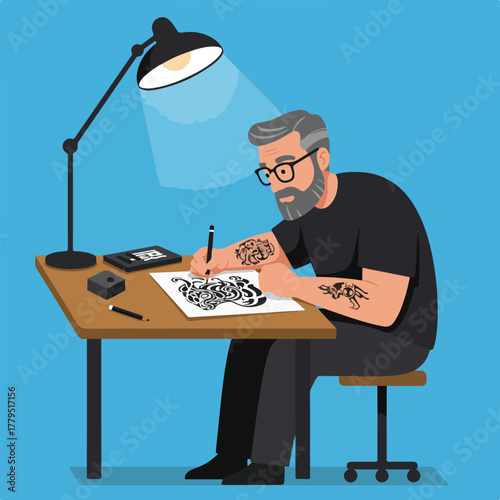 A person with tattoos meticulously draws at a desk under a lamp, showcasing design skills