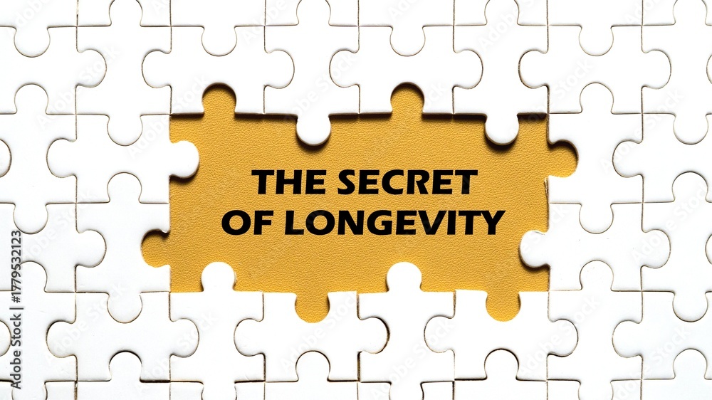 Fototapeta premium The concept of the words THE SECRET OF LONGEVITY in the middle of the puzzle. Yellow background.