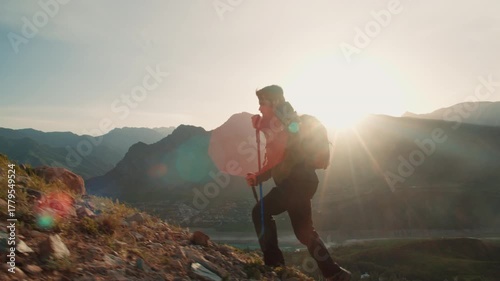 Man climbing mountain path with trekking poles in morning light concept of mindfulness strength adventure self discipline freedom and harmony with nature outdoor spirit motivation