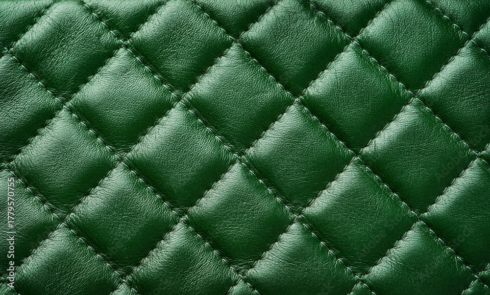 Fototapeta premium Green leather texture background with diagonal stitching. Close up seamless green leather with diagonal diamond stitching. Design element.