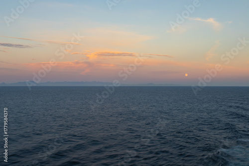 Fototapeta Naklejka Na Ścianę i Meble -  seascape at sunset with the moon low in the sky