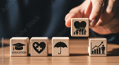 Hand placing family icon block on top of growth and education blocks
