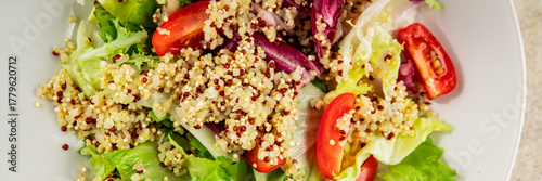 Quinoa salad tomato, green leaf salad vegetables dish natural product tasty snack fresh gourmet food background on the table rustic top view copy space keto and paleo diet vegan and vegan food