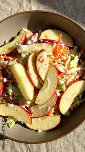 Fresh vibrant salad with crisp apple slices in sunlit kitchen setting