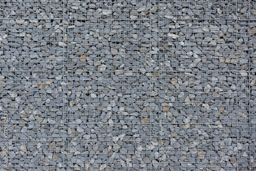 Gabion made of gray crushed stone as a background, texture, pattern.