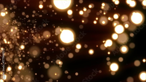 Loop animation of a luminous Christmas shooting star with a tail of golden particles on a black background