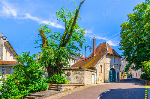 Fototapeta Naklejka Na Ścianę i Meble -  Road street leading up in Besancon old town centre ville, La boucle de Besançon city historic centre with medieval buildings in sunny summer day, Bourgogne-Franche-Comte region, France