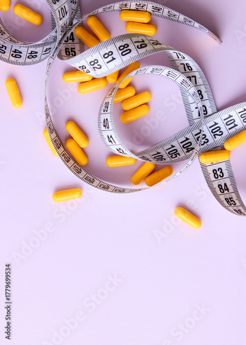 Wallpaper Mural Measuring tape and diet pills on a colored background close-up.. Vertical photo format.  Torontodigital.ca