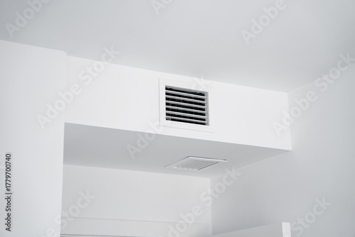 Ventilation grille and air duct in modern white minimalist room interior