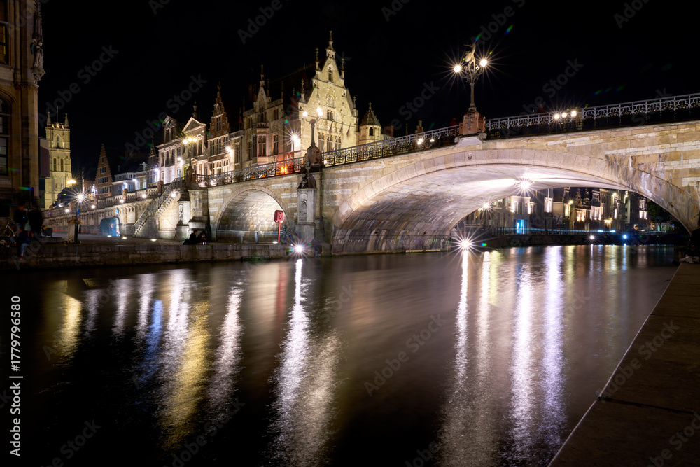 Fototapeta premium St. Michael’s Bridge at Night Ghent Belgium. Evening in Ghent, Belgium on the banks of the Leie river and the St. Michael’s Bridge amongst the medieval buildings of the old town.