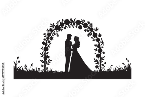 Silhouette of a bride and groom under a floral wedding arch