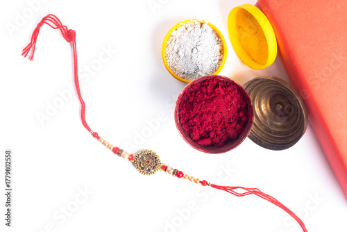 Rakhi bangle with colored powders for the celebration of the Indian festival of Raksha Bandhan.