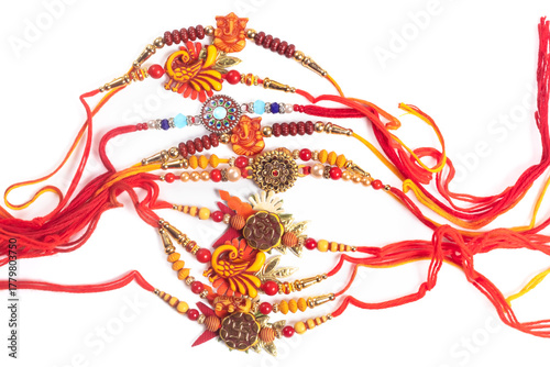Colorful beaded bangles with red threads and floral decorations for Raksha Bandhan.
