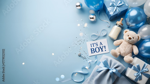 Newborn Baby Boy Gift Set with Clothes, Teddy Bear, and Accessories on Blue Background