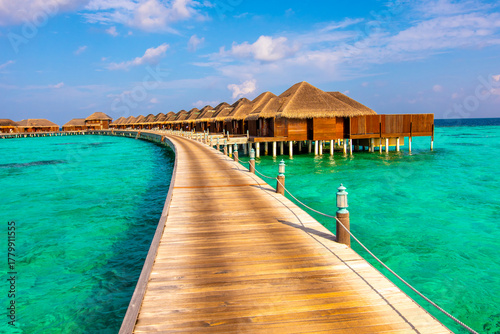 Fototapeta Naklejka Na Ścianę i Meble -  Wooden pathway to bungalows. Summer vacation, holiday amazing nature. Relax paradise, Maldives. Tropical island beach landscape exotic shore coast. Tranquil closeup calm sea water waves.