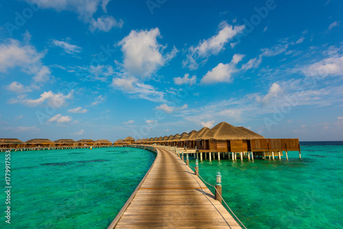 Fototapeta Naklejka Na Ścianę i Meble -  Wooden pathway to bungalows. Summer vacation, holiday amazing nature. Relax paradise, Maldives. Tropical island beach landscape exotic shore coast. Tranquil closeup calm sea water waves.
