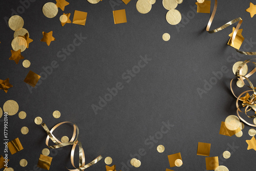 frame of gold streamers and confetti on a black background with copy space