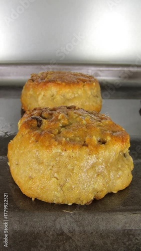 Oatmeal cookies cooking time lapse in oven.  Vertical view.