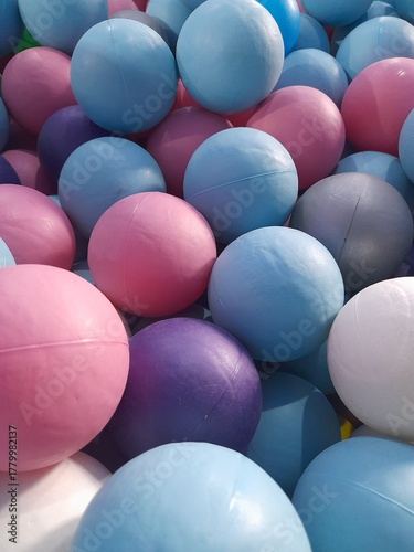 A colorful ball pit. Colored plastic balls in pool of game room. Swimming pool for fun and jumping in colored plastic balls