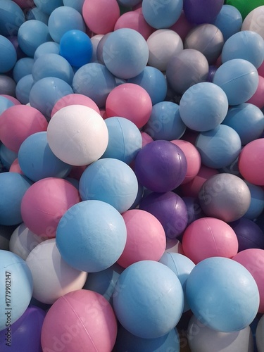 A colorful ball pit. Colored plastic balls in pool of game room. Swimming pool for fun and jumping in colored plastic balls