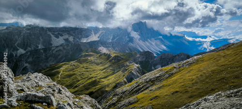 Hiking in the Italian Alps. The Roda de Putia hiking route in the Dolomites. The trail to Mount Peitlerkofel. Colorful landscapes of the mountain range, hiking trails, and huts nearby.