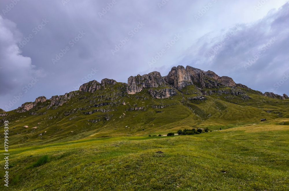 Fototapeta premium Hiking in the Italian Alps. The Roda de Putia hiking route in the Dolomites. The trail to Mount Peitlerkofel. Colorful landscapes of the mountain range, hiking trails, and huts nearby.