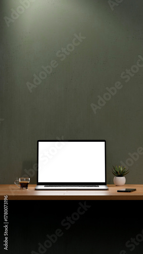 Blank screen of laptop for mockup. Workspace with computer, coffee cup, plant and mobile phone. 8k high resolution in Vertical format.