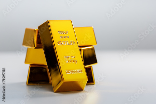 Stack of gold bars on grey background with space for text.