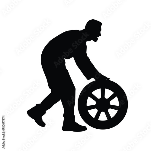 Silhouette of a male figure bending and actively rolling a heavy automotive tire or wheel. This image symbolizes car repair, manual work, maintenance, garage service, tire shop, and physical effort.