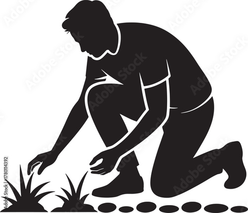 Silhouette of a gardener planting grass, laying stone path in outdoor space