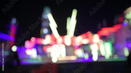Out of focus amusement park ride lights lit up at the Minnesota state fair