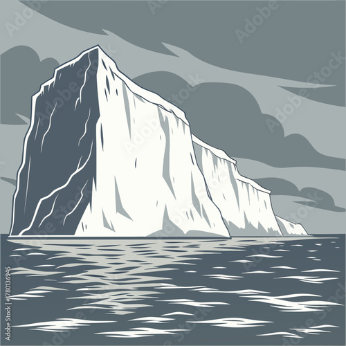 A large iceberg floating in the ocean under a cloudy sky landscape