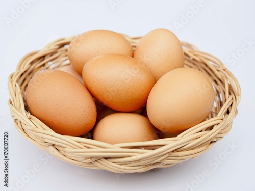 Wallpaper Mural Several fresh chicken eggs are placed in a basket on a white background. Torontodigital.ca