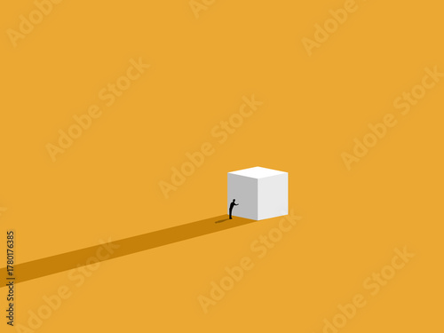 Working hard, a businessman tries to push a white box