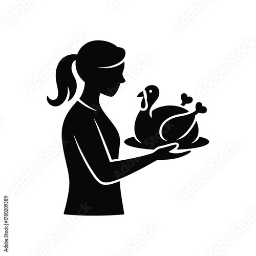 Silhouette of a woman holding a roasted turkey on a platter