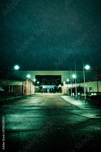 Modern school building on a rainy night in winter. 