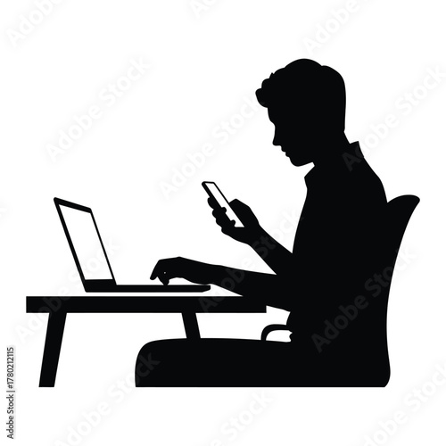 Silhouette of a person working on a laptop and using a smartphone