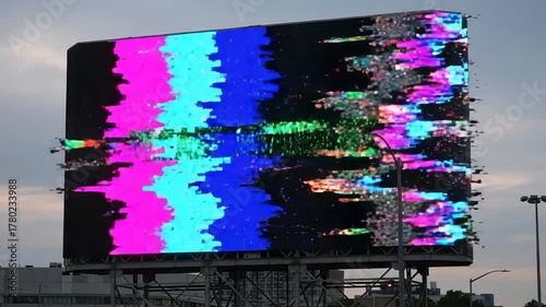 Digital Billboard Displaying Please Stand By Sign with Glitch Effect in Urban Outdoor Setting