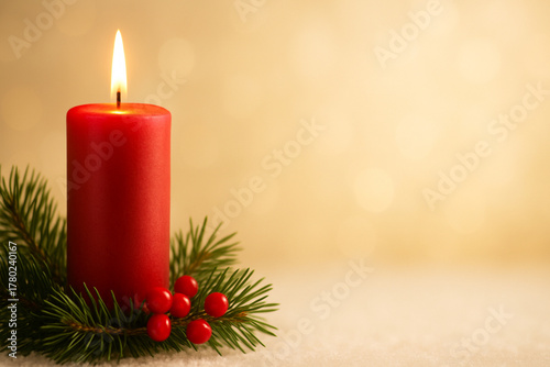 A tall, elegant red candle with a glowing flame, nestled in a bed of pine needles and small holly berries. Defocused background in warm white and gentle gold tones, perfect for text overlay.