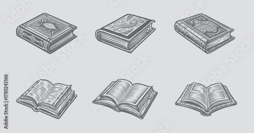 Assortment of old books with detailed engravings and textured pages on gray