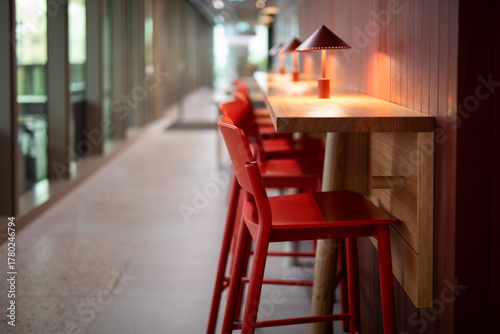 Modern Cafe Seating with Red Stools and Warm Lighting