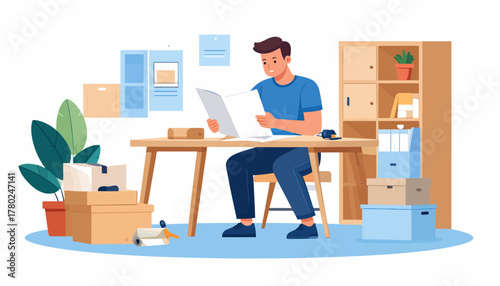 A focused young man in a casual blue t-shirt sitting at a desk while carefully reviewing a document.