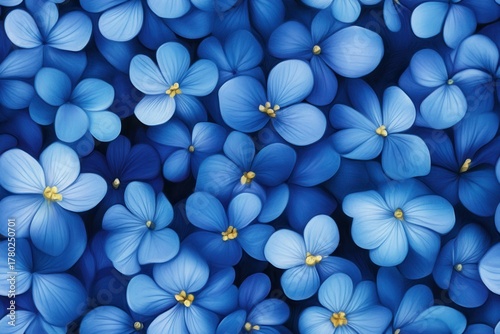 Vibrant Blue Floral Pattern with Varying Shades of Blue Blooms and Yellow Accents