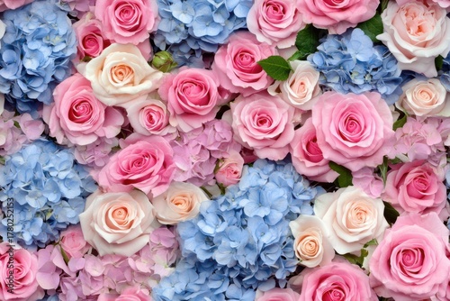 A Stunning Floral Arrangement Showcasing the Beauty of Pink Roses and Blue Hydrangeas in Full Bloom