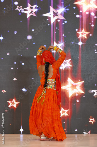 Portrait of an unidentified female artist performing classical dance in ethnic indian clothes.