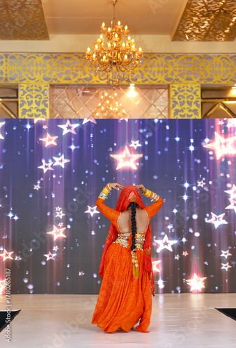 Portrait of an unidentified female artist performing classical dance in ethnic indian clothes.